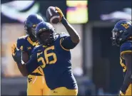  ?? WILLIAM WOTRING — THE DOMINION-POST VIA THE ASSOCIATED PRESS ?? In an Oct. 17, 2020, photo, West Virginia defensive lineman Darius Stills reacts after making an intercepti­on against Kansas during a game in Morgantown, W.Va.