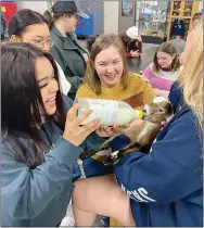  ?? ?? Students Vanessa Carlos, Megan Kindy and Haylea Vinson feed a baby goat in Advanced Animal Science class.