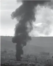  ?? — AFP, AP ?? An image grab ( above, left) taken from a video uploaded on Sunday by Aamaq News Agency, a Youtube channel which posts videos from areas under ISIS control, allegedly shows ISIS militants taking shooting positions in the town of Kobane, on the Syria-...