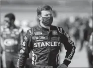  ?? PAUL SANCYA/AP PHOTO ?? Erik Jones waits to enter his car before a NASCAR Cup race at Michigan Internatio­nal Speedway on Aug. 8.