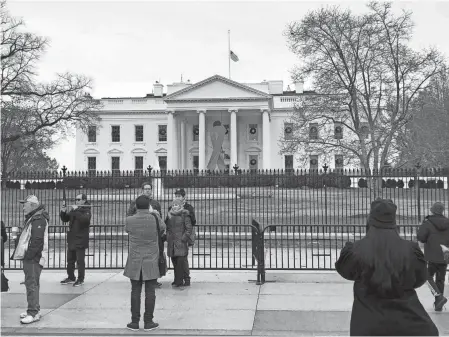  ??  ?? The flag flies at half-staff to mark the death of former President George H.W. Bush.