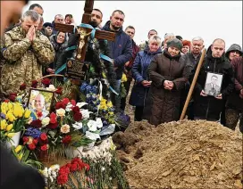  ?? WALLY SKALIJ/LOS ANGELES TIMES/TNS ?? Mourners gather Wednesday at the funeral of two Ukrainian soldiers killed by a Russian missile in Starychi, Ukraine. One expert said while Russia wins the shooting war, winning at informatio­n is key to Ukraine gaining allies’ support.