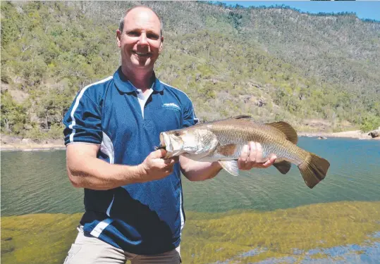  ?? FISHING PARADISE: Hinchinbro­ok Adventures owner and pilot Josh Liddle with a barramundi from the spectacula­r Herbert River ( ?? below).