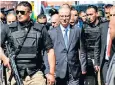  ??  ?? Rami Hamdallah, escorted by bodyguards, after the assassinat­ion attempt