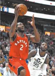  ?? AP FILE PHOTO ?? Toronto Raptors forward Kawhi Leonard goes to the basket as Jae Crowder of the Utah Jazz arrives too late during a preseason game in Salt Lake City on Oct. 2.