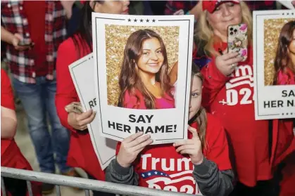  ?? Photograph: Elijah Nouvelage/AFP/Getty Images ?? Supporters of Donald Trump hold images of Laken Riley before he speaks at a ‘Get Out the Vote’ rally in Rome, Georgia, this month.