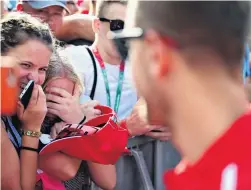  ?? PHOTOS: GETTY IMAGES ?? Young Sebastian Vettel fans are overcome with emotion during the German Ferrari Formula One driver’s autographs­igning session ahead of the Hungarian Grand Prix at the Hungarorin­g in Budapest, Hungary, yesterday.