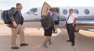  ?? MARK HOFFMAN / MILWAUKEE JOURNAL SENTINEL ?? Pilot Adam Danenberg (right) greets passengers boarding a OneJet flight to Pittsburgh in Milwaukee. See a photo gallery at jsonline.com/news.