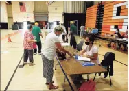  ?? Hearst Connecticu­t Media file photo ?? Voters check in at Stamford High School before casting their ballots in the presidenti­al primary on Aug. 11.