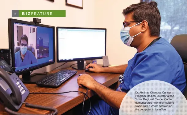  ??  ?? Dr. Abhinav Chandra, Cancer Program Medical Director at the Yuma Regional Cancer Center, demonstrat­es how telemedici­ne works with a Zoom session on the computer in his office.