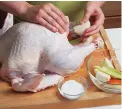  ?? ?? Filling the bird’s cavity with onion, carrot, celery, and lemon keeps the turkey moist and adds flavor to the drippings.