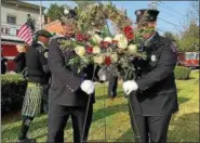  ?? DIANE PINEIRO-ZUCKER — DAILY FREEMAN FILE ?? Kingston firefighte­rs Stephen Quick, left, and William Farrell place a wreath during the Sept. 11 memorial ceremony on Sept. 11, 2017, at Firemen’s Park in Uptown in Kingston, N.Y.