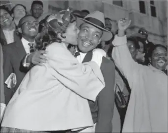  ?? GENE HERRICK — THE ASSOCIATED PRESS FILE ?? In this file photo, the Rev. Martin Luther King Jr. is welcomed with a kiss by his wife, Coretta, after leaving court in Montgomery, Ala. Court records from the arrests of Rosa Parks, Martin Luther King Jr. and others at the dawn of the modern civil...