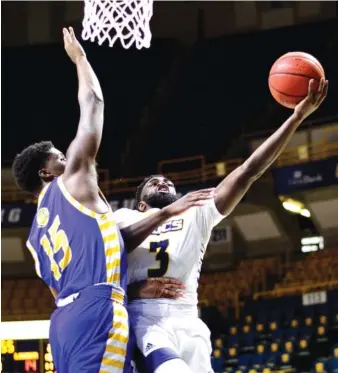  ?? STAFF PHOTO BY ROBIN RUDD ?? UTC’s David Jean-Baptiste shoots against Lander’s Zane Rankin during Wednesday’s game at McKenzie Arena, the opener of the Mocs’ fourth season with Lamont Paris as coach.