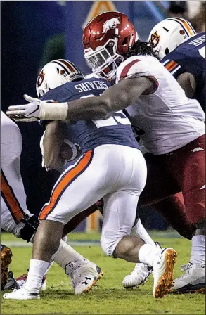  ?? NWA Democrat-Gazette/BEN GOFF ?? Arkansas defender McTelvin Agim (right) wraps up Auburn running back Shaun Shivers during Saturday’s game. Despite their 1-3 record, the Razorbacks lead the SEC and rank seventh nationally in rushing defense, allowing 89.3 rushing yards per game.