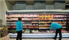  ?? — Reuters ?? Workers pack fruit at an outlet of retailer Shoprite Checkers in Cape Town.