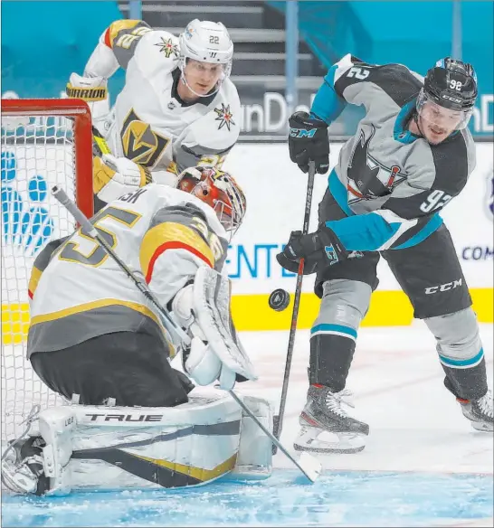  ?? Josie Lepe The Associated Press ?? Golden Knights goaltender Oscar Dansk stops a shot from in close by Rudolfs Balcers of the Sharks during the second period of Friday night’s game in San Jose, Calif.