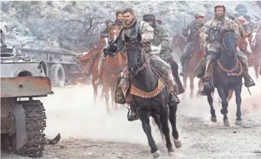  ??  ?? Mitch Nelson (Chris Hemsworth) leads his Green Berets into battle in the war drama
“12 Strong.” PHOTOS BY DAVID JAMES