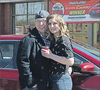  ?? – John DeCoste, www.kingscount­ynews.ca ?? Amanda Macdonald and her boyfriend Leigh Rockwell with their new Toyota Camry, which Macdonald won as part of Tim Horton’s RRRoll Up The Rim to win promotion.