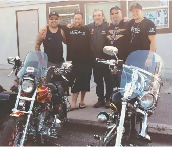  ??  ?? Surrey Police Board member Harley Chappell, left, poses with two members of the White Rock Hells Angels, Douglas (Doc) Riddoch, centre, and Brent Milne, second from right, at an August 2018 memorial service.