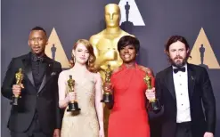  ?? —AFP ?? HOLLYWOOD: (From left) Best Supporting Actor Mahershala Ali, Best Actress Emma Stone, Best Supporting Actress Viola Davis and Best Actor Casey Affleck pose in the press room during the 89th Oscars on Sunday.