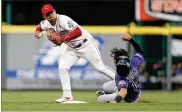  ?? GARY LANDERS / AP ?? Colorado catcher Tony Wolters (right) is forced out at second Friday as Cincinnati shortstop Jose Iglesias (4) tries to turn a double play on pitcher German Marquez. Marquez beat the throw.