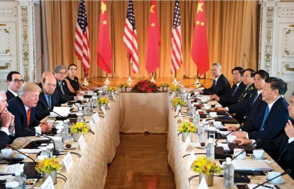  ??  ?? THOUGH TALK The U.S. might persuade China to change its trade practices by focusing on “enforceabl­e reciprocit­y.” From left: Trump and Xi hold talks at Mar-a-lago in 2017; Commerce Secretary Wilbur Ross; cars ready for shipment at the Lianyungan­g Port in May 2018.