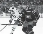  ?? PAUL VERNON/AP ?? Alexander Nylander skates in front of Sharks defenseman Henry Thrun during Columbus' 4-2 win Saturday. Nylander scored twice in the victory.