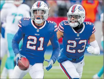  ?? GETTY IMAGES ?? Jordan Poyer (21) of the Bills celebrates with teammate Micah Hyde after making one of three intercepti­ons that Dolphins QB Jay Cutler threw during yesterday’s game at New Era Field. The Bills kept their playoff hopes alive with a 24-16 win.