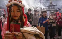  ?? AP ?? HONG KONG: Worshipper­s offer incense Saturday at the Che Kung temple to welcome in the Lunar New Year.