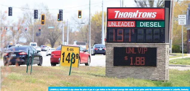  ??  ?? LOUISVILLE, KENTUCKY: A sign shows the price of gas at a gas station as the national average falls under $2 per gallon amid the coronaviru­s pandemic in Louisville, Kentucky. Saudi Arabia and Russia are ‘very, very close’ to a deal on oil production cuts, Kirill Dmitriev, head of Russiaís sovereign wealth fund, told CNBC yesterday.— AFP
