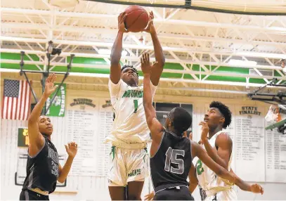  ?? PAUL W. GILLESPIE/CAPITAL GAZETTE ?? Arundel’s Quaadir Spence scores and is fouled for a three point play in the second quarter. The Arundel Wildcats played the visiting Meade Mustangs in the 4A East Region I championsh­ip game Thursday evening.