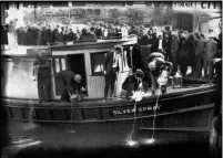  ?? CHARLES S. BORJES — THE ASSOCIATED PRESS ?? In 1922, spectators gather by the side of captured rum runner, Silver Spray, as they watch prohibitio­n agents pour “white lightning” from the five-gallon bottles on the deck into the Elizabeth River, Norfolk, Va. The Prohibitio­n Era, which lasted from Jan. 17, 1920, until December 1933, is now viewed as a failed experiment that glamorized illegal drinking.