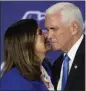  ?? JOHN LOCHER — THE ASSOCIATED PRESS ?? Karen Pence, left, kisses former Vice President Mike Pence on Saturday in Las Vegas.