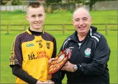  ??  ?? Eddie Leonard presents Ashford captain Josh Nichols with the Shield.