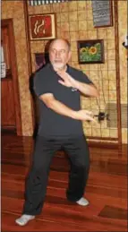  ??  ?? Tai Chi Instructor Jan Gyomber practices some moves before his evening class at Healing Yoga Studio in Douglassvi­lle. Tai Chi is a Chinese healing art that incorporat­es mindfulnes­s.