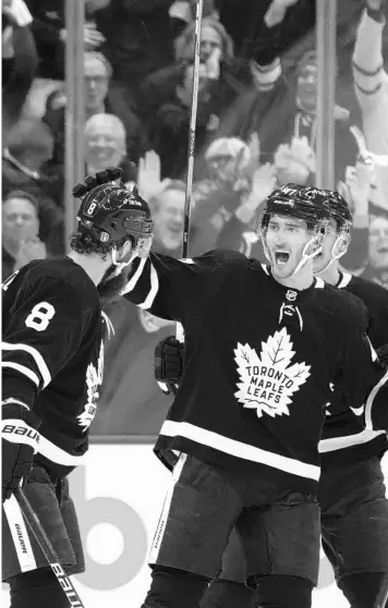  ?? NATHAN DENETTE/AP ?? Toronto Maple Leafs defenseman Jake Muzzin (8) celebrates his goal with teammate Pierre Engvall (47) during the first period on Monday night.