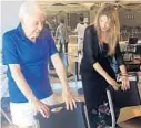  ??  ?? Phil Vairo, 84, of Boca Raton, performs a stretch routine using a chair with instructor Marie Giguere.