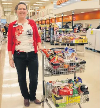  ?? MILLICENT MCKAY/JOURNAL PIONEER ?? Pam Smallman, manager of Atlantic Superstore Summerside recently loaded up on storm food including storm chips, pre-prepared fruit and veggie trays, bread, milk and more.