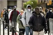  ?? MATT ROURKE - THE ASSOCIATED PRESS ?? People wait in line to receive food as part of a new initiative called Step Up to the Plate, outside City Hall in Philadelph­ia, Friday, April 17.