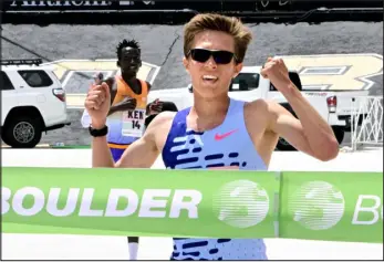  ?? CLIFF GRASSMICK — STAFF PHOTOGRAPH­ER ?? Connor Mantz approaches the finish line at the 43rd Bolder Boulder on Monday, with Kenya’s Alex Masai chasing. Mantz claimed the men’s profession­al title while helping Team USA to a second-place finish in the Internatio­nal Team Challenge.