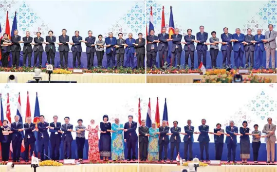  ?? HONG MENEA ?? ASEAN foreign ministers and other officials cross arms and hold hands for photos at the 55th ASEAN Foreign Ministers’ Meetings (AMM).
