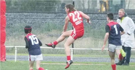  ??  ?? Above: Trafalgar’s Jack Hart boots the ball into attack;
Photograph­s: Paul Cohen.