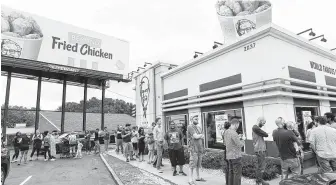  ?? John Amis / Associated Press ?? Consumers stood in line at an Atlanta KFC throughout the day last month to be among the first to try Beyond Fried Chicken, a plant-based chicken made in partnershi­p with Beyond Meat.