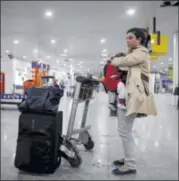  ?? REUTERS ?? A woman waits to leave Yemen at Sanaa Airport on Saturday. Saudi diplomats left Yemen and the U.N. pulled out staff Saturday after Saudi-led airstrikes continued to try to stem advances by Houthi fighters.