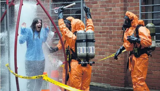  ?? PHOTO: CRAIG BAXTER ?? Method acting . . . An actor experience­s a decontamin­ation shower during an emergency exercise at the Dunedin Medical School yesterday.