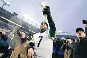  ?? AP Photo/Evan Vucci ?? ■ Pittsburgh Steelers quarterbac­k Ben Roethlisbe­rger hands a spectator a towel as he walks off the field after an NFL football game against the Baltimore Ravens on Jan. 9 in Baltimore. The Steelers won, 16-13.