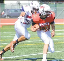  ?? Pete Paguaga / Hearst Connecticu­t Media ?? Connecticu­t’s Mike Casinelli, from Shelton, tackles Rhode Island’s Eric Dahlberg during Saturday’s Governor’s Cup in New Britain.