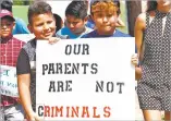  ?? ROGELIO SOLIS ASSOCIATED PRESS ?? Children of Latino immigrant parents hold signs Sunday in Canton, Miss., protesting an immigratio­n raid last week.