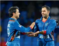  ?? — AFP file ?? Mohammad Nabi (right) and Mujeeb Ur Rahman (not in picture) took three wickets each, but Afghanista­n lost the match on DLS method.